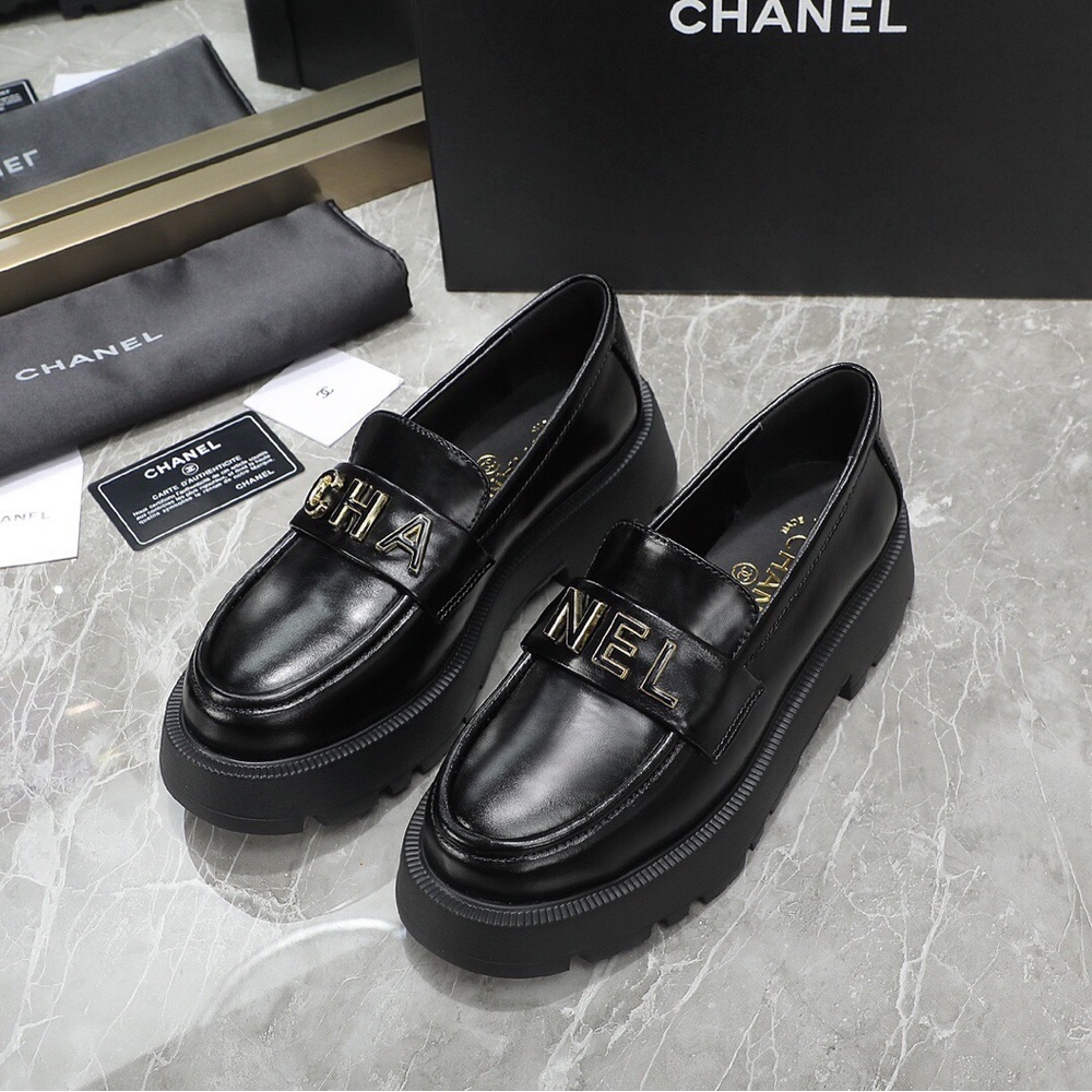 CHANEL Black Leather Loafers with Gold Accents